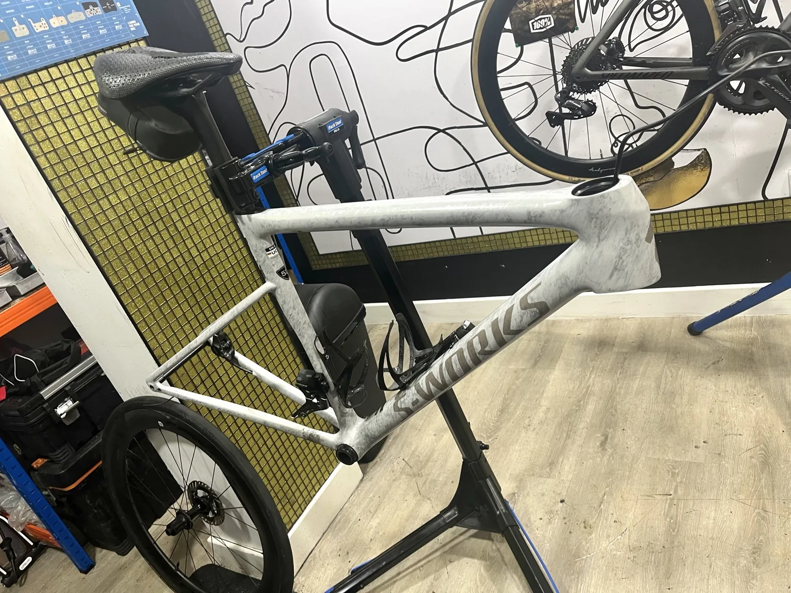 White performance road bike in the workshop